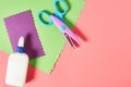 Scissors for decorative curly cutting, glue bottle and blank paper sheets for craft with wave border on pink background Royalty Free Stock Photo
