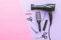 Scissors and other hairdresser's accessories on lilac-pink background, flat lay. Space for text Royalty Free Stock Photo