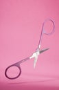 Scissors opened isolated in pink background