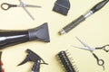 Scissors and other hair styling tools on yellow background Royalty Free Stock Photo