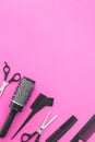 Scissors and other hairdresser's accessories on pink background, flat lay. Space for text Royalty Free Stock Photo
