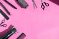 Scissors and other hairdresser's accessories on pink background, flat lay. Space for text Royalty Free Stock Photo