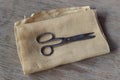 Scissors on a piece of natural-colored linen fabric