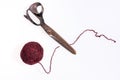 Scissors and a red ball of woolen thread isolated Royalty Free Stock Photo