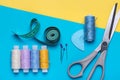 Scissors, set of sewing needles and bright colored threads on reels. Royalty Free Stock Photo