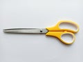 Scissors stainless steel yellow and white handle. Royalty Free Stock Photo