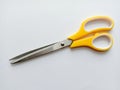 Scissors stainless steel yellow and white handle. Royalty Free Stock Photo