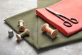 Scissors, threads and fabric on grey table. Tailoring equipment Royalty Free Stock Photo