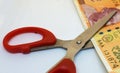 Scissors try to cut Indian two hundred rupees note on a white background. Split money, financial share, devaluation of currency, Royalty Free Stock Photo