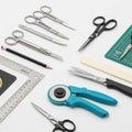 Scissors of varying sizes, a rotary cutter with a blue handle, a Royalty Free Stock Photo
