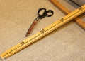 scissors and the wooden meter in artisan tailoring Royalty Free Stock Photo