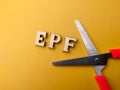 Scissors and wooden word with text EPF Royalty Free Stock Photo