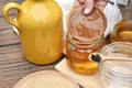 Scoby, Hand holding tea mushroom with kombucha tea, Healthy fermented food, Probiotic nutrition drink for good balance.