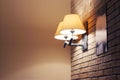 Sconce with yellow lamp shade on brick wall Royalty Free Stock Photo