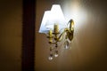 Sconces hanging on the wall upholstered in fabric Royalty Free Stock Photo