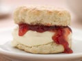 Scone Filled with Strawberry Jam and Clotted Cream Royalty Free Stock Photo