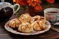 scones on a charming ceramic plate with a cup of tea Royalty Free Stock Photo