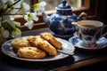 scones on a charming ceramic plate with a cup of tea Royalty Free Stock Photo