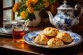 scones on a charming ceramic plate with a cup of tea Royalty Free Stock Photo