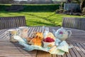Scones with cups of tea in an English country garden. Royalty Free Stock Photo