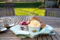 Scones with cups of tea in an English country garden. Royalty Free Stock Photo