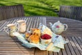 Scones with cups of tea in an English country garden. Royalty Free Stock Photo