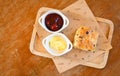 scones and jam on wooden plate, served scones and cream for dessert and tea - fresh homemade butter scones Royalty Free Stock Photo