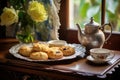 scones and tea set on a vintage tray in a cozy setting Royalty Free Stock Photo