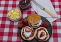 Scones topped with strawberry jam,cream and fresh fruit Royalty Free Stock Photo