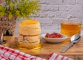 Scones traditional English delicious freshly baked homemade, strawberry jam on a wooden tray. Royalty Free Stock Photo