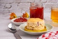 Scones traditional English delicious freshly baked homemade, strawberry jam on a wooden tray Royalty Free Stock Photo