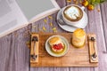 Scones traditional English delicious freshly baked homemade with strawberry jam served on a wooden tray with a coffee cup and a Royalty Free Stock Photo