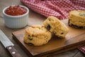 Scones on wooden plate and jam in bowl
