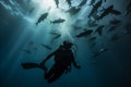 a scooba diver diving underwater with sharks in the ocean Royalty Free Stock Photo