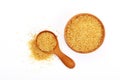 Scoop and bowl of brown cane sugar on white Royalty Free Stock Photo