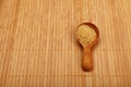 Scoop of brown cane sugar on bamboo mat Royalty Free Stock Photo