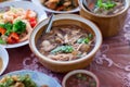 scoop Chinese style soup; or braised fish maw in red gravy with eggs, mushroom, and bamboo shoot in white bowl. Royalty Free Stock Photo