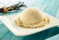 Scoop of creamy vanilla ice cream on a plate