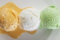 Scoop of delicious real fresh ice cream in Mango, Vanilla and Pistachio flavour. Royalty Free Stock Photo