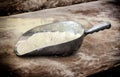 Scoop of flour on wooden table Royalty Free Stock Photo