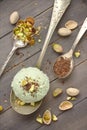 Scoop of homemade pistachio ice cream with chopped pistachios and chocolate Royalty Free Stock Photo