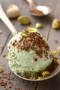 Scoop of homemade pistachio ice cream with chopped pistachios and chocolate Royalty Free Stock Photo