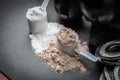 Scoop of protein powder and dumbbell background,Sports supplement,Fitness or healthy lifestyle concept. selective focus