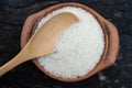 Scoop rice by using a ladle in a clay pot Royalty Free Stock Photo
