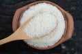 Scoop rice by using a ladle in a clay pot Royalty Free Stock Photo