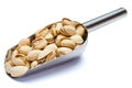 Scoop of Roasted pistachios nuts isolated on white background. Clipping path