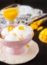 Scoop Vanilla ice cream with mango fruits and puree. Royalty Free Stock Photo