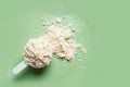 Scoop of whey protein powder on green Royalty Free Stock Photo