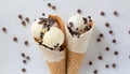 Scoops of chocolate and vanilla ice cream with chocolate chips, in waffle cones Royalty Free Stock Photo