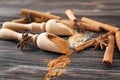 Scoops with cinnamon powder and sugar on wooden background, closeup Royalty Free Stock Photo